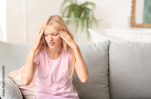 Stressed young woman at home