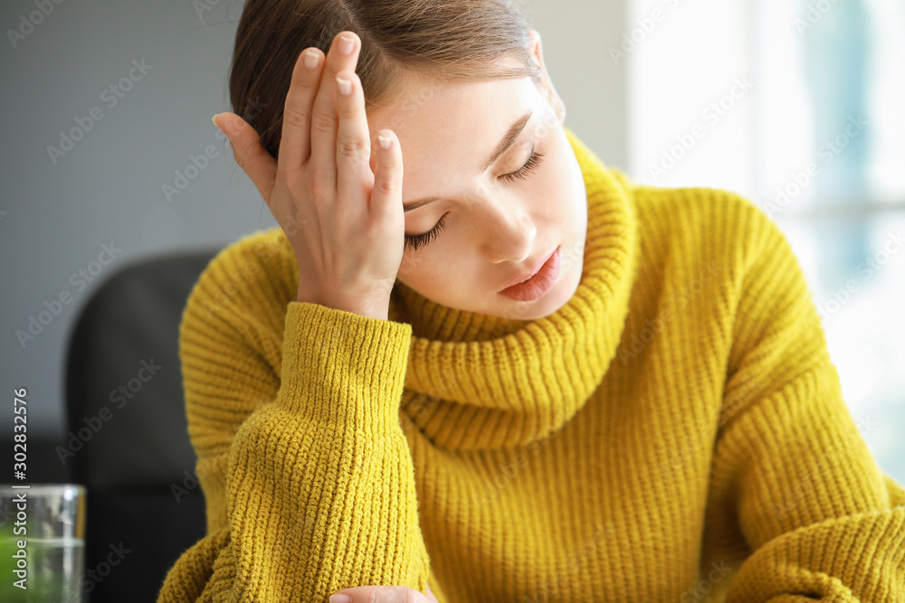 Young woman suffering from headache at home Young woman suffering from headache at home
