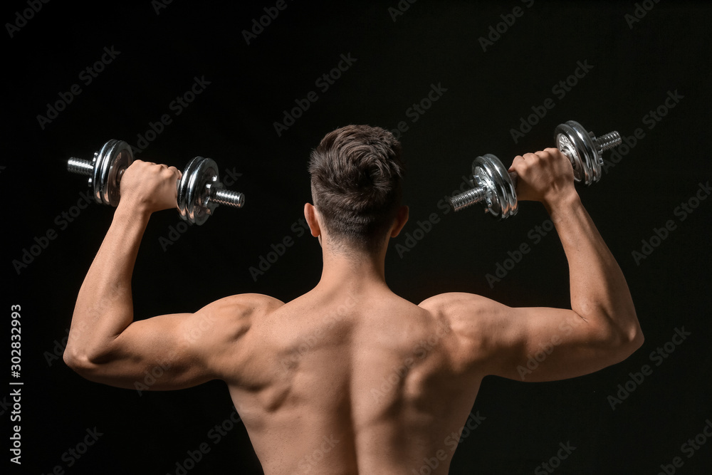Sporty young man with dumbbells on dark background Sporty young man with dumbbells on dark background