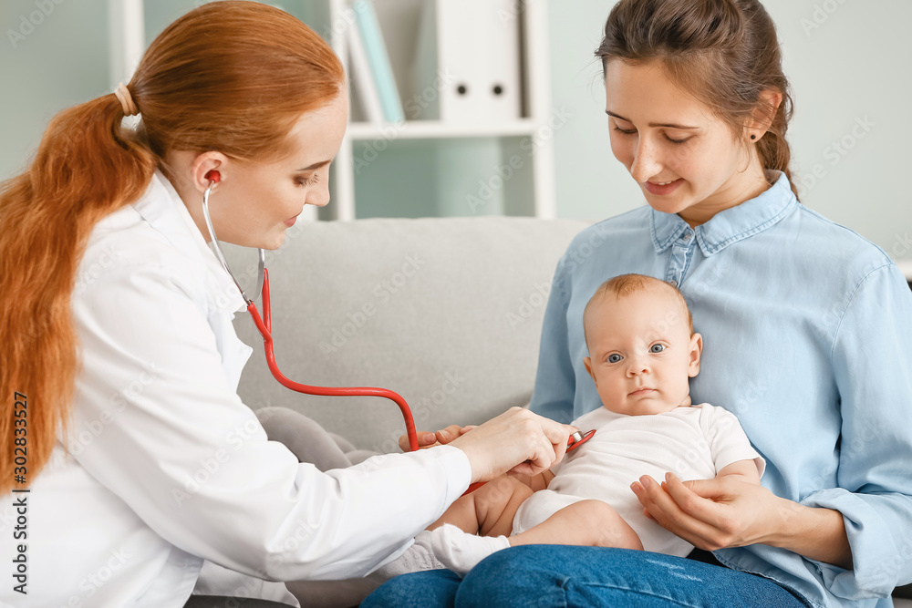 Woman with little baby visiting pediatrician in clinic Woman with little baby visiting pediatrician in clinic