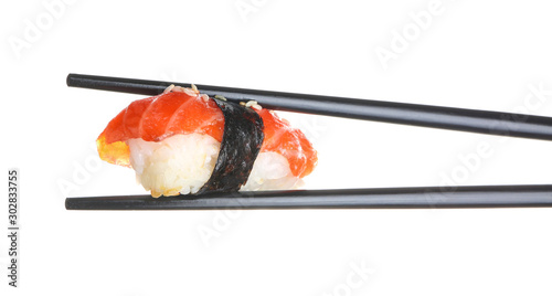 Chopsticks with tasty sushi on white background