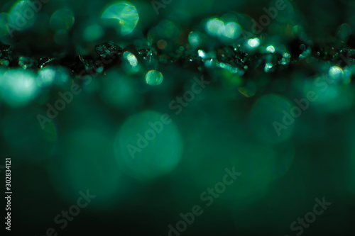 Monochrome emerald abstract background with bokeh defocused lights.