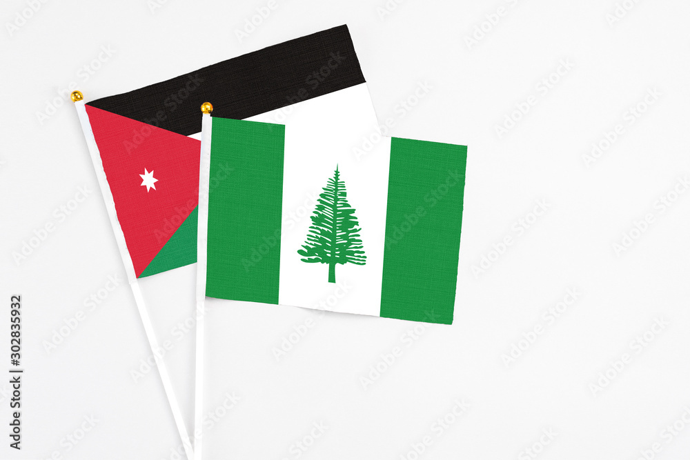 Norfolk Island and Jordan stick flags on white background. High quality fabric, miniature national flag. Peaceful global concept.White floor for copy space. Norfolk Island and Jordan stick flags on white background. High quality fabric, miniature national flag. Peaceful global concept.White floor for copy space.