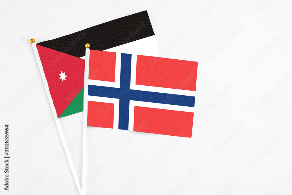 Norway and Jordan stick flags on white background. High quality fabric, miniature national flag. Peaceful global concept.White floor for copy space.