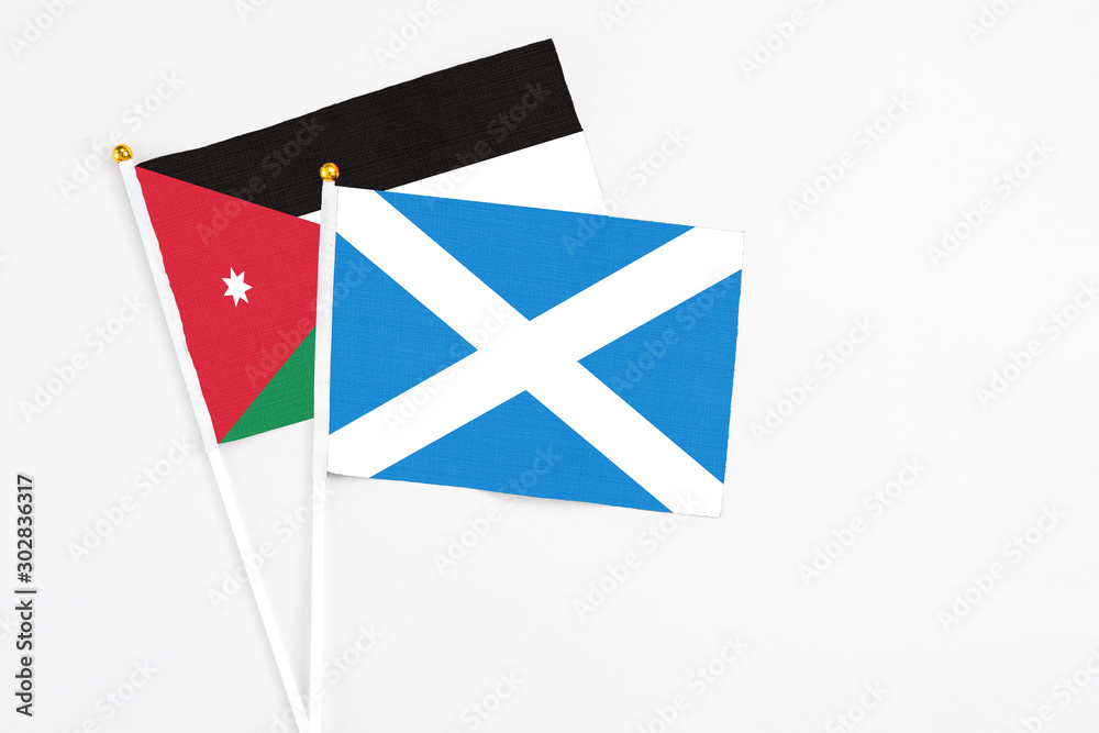 Scotland and Jordan stick flags on white background. High quality fabric, miniature national flag. Peaceful global concept.White floor for copy space. Scotland and Jordan stick flags on white background. High quality fabric, miniature national flag. Peaceful global concept.White floor for copy space.