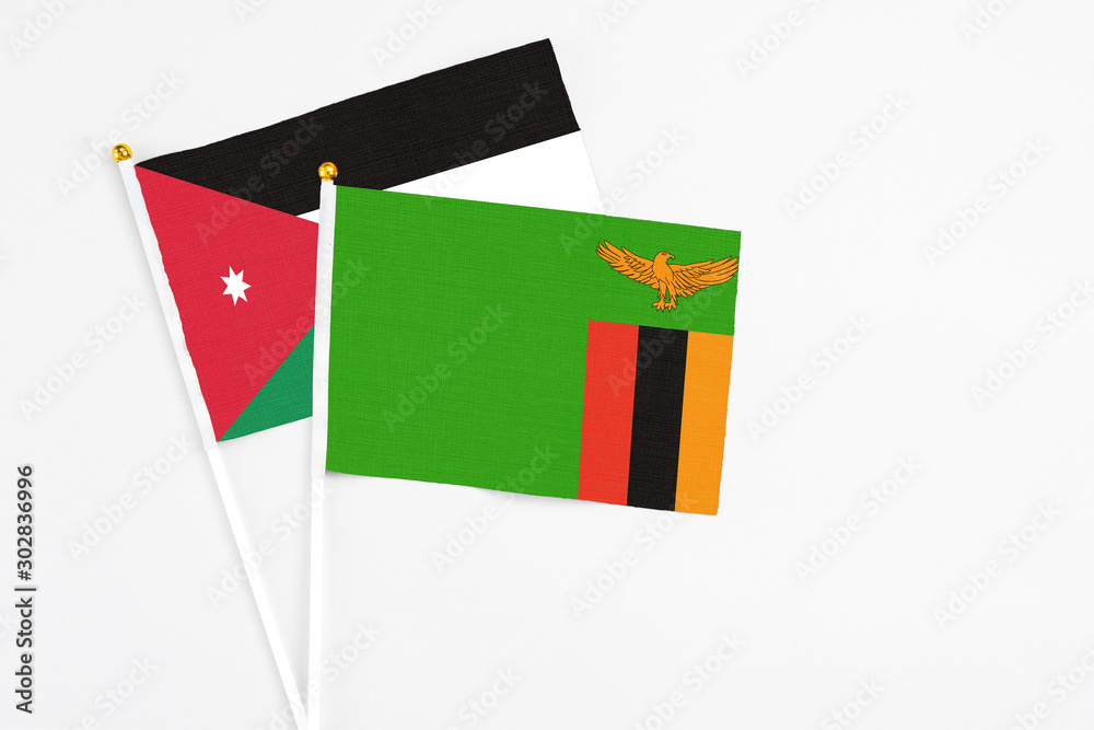 Zambia and Jordan stick flags on white background. High quality fabric, miniature national flag. Peaceful global concept.White floor for copy space. Zambia and Jordan stick flags on white background. High quality fabric, miniature national flag. Peaceful global concept.White floor for copy space.