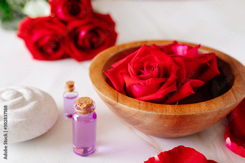 Spa bath product with rose oil and.Rose petals on a white background. Spa bath product with rose oil and.Rose petals on a white background.