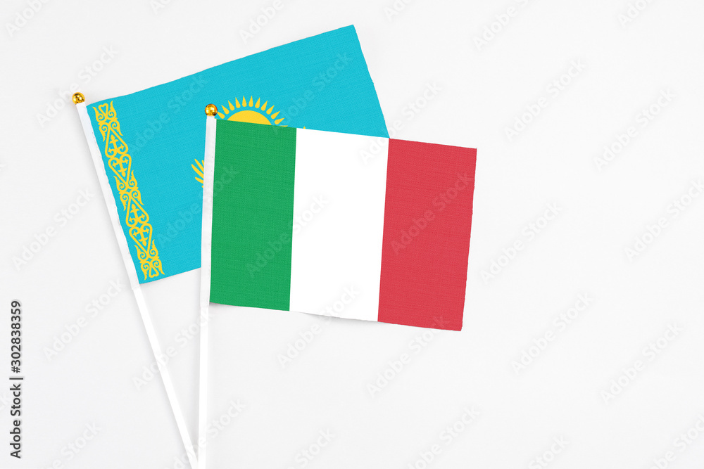 Italy and Kazakhstan stick flags on white background. High quality fabric, miniature national flag. Peaceful global concept.White floor for copy space. Italy and Kazakhstan stick flags on white background. High quality fabric, miniature national flag. Peaceful global concept.White floor for copy space.