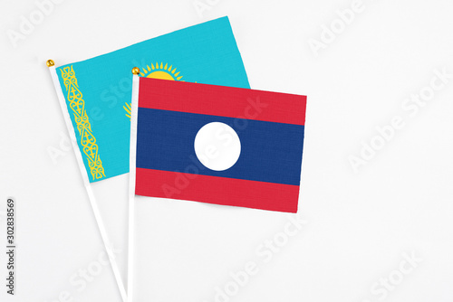 Free Download Laos and Kazakhstan stick flags on white background. High quality fabric, miniature national flag. Peaceful global concept.White floor for copy space. - GFXLoad