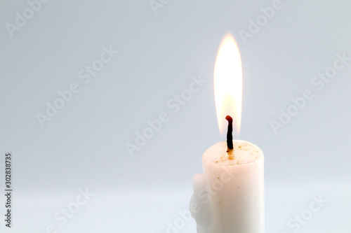 white candle on gray background