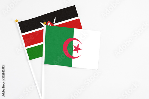 Free Download Algeria and Kenya stick flags on white background. High quality fabric, miniature national flag. Peaceful global concept.White floor for copy space. - GFXLoad