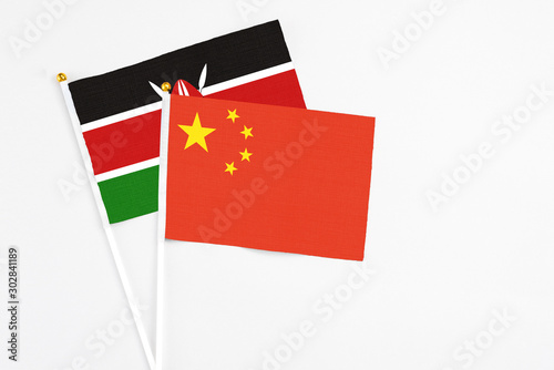 China and Kenya stick flags on white background. High quality fabric, miniature national flag. Peaceful global concept.White floor for copy space.