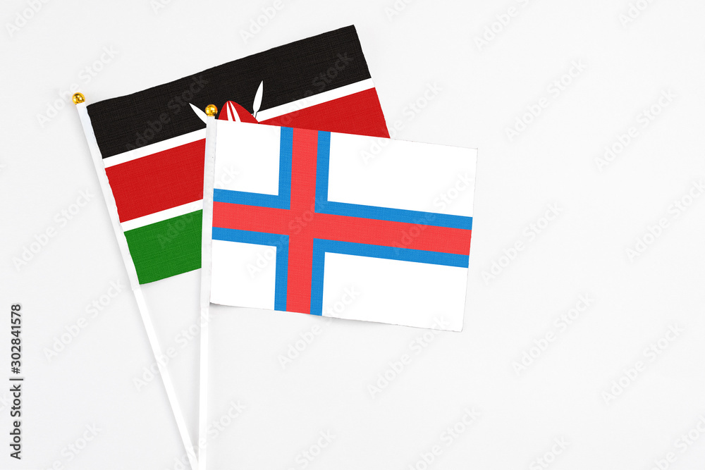 Faroe Islands and Kenya stick flags on white background. High quality fabric, miniature national flag. Peaceful global concept.White floor for copy space.