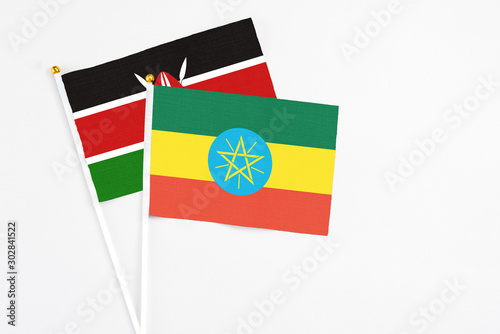 Ethiopia and Kenya stick flags on white background. High quality fabric, miniature national flag. Peaceful global concept.White floor for copy space. photo