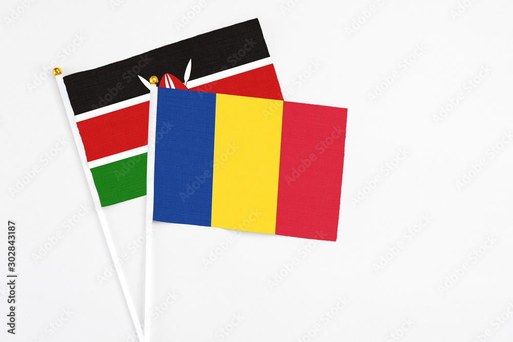 Romania and Kenya stick flags on white background. High quality fabric, miniature national flag. Peaceful global concept.White floor for copy space. Romania and Kenya stick flags on white background. High quality fabric, miniature national flag. Peaceful global concept.White floor for copy space.