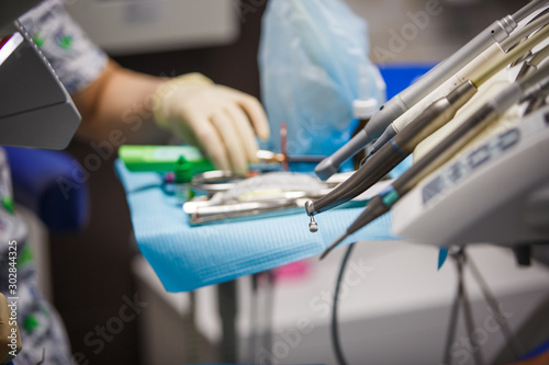 Working tools of the dentist. A cast of the jaw  Bor machine  work space and treatment of the patient in the blur