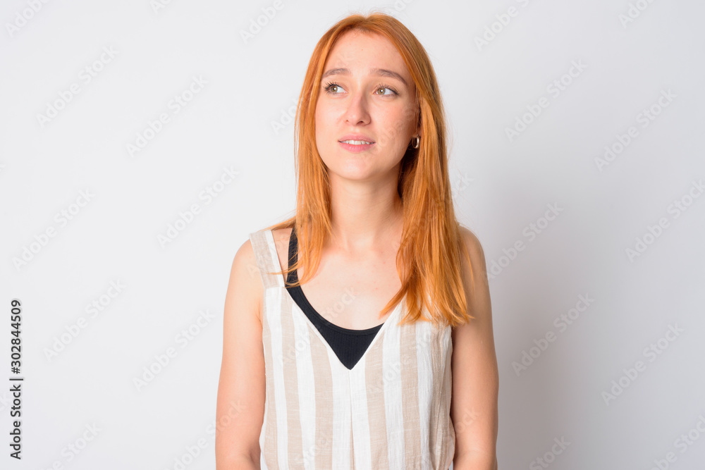 Face of happy young beautiful redhead woman thinking Face of happy young beautiful redhead woman thinking