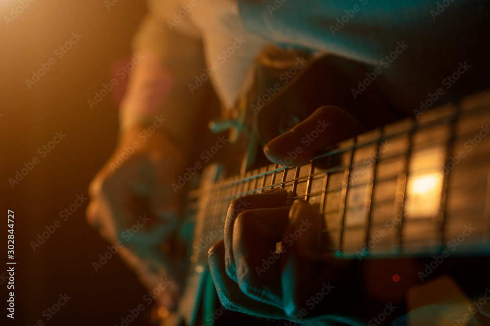 Fototapeta premium Guy plays a melody on the stage