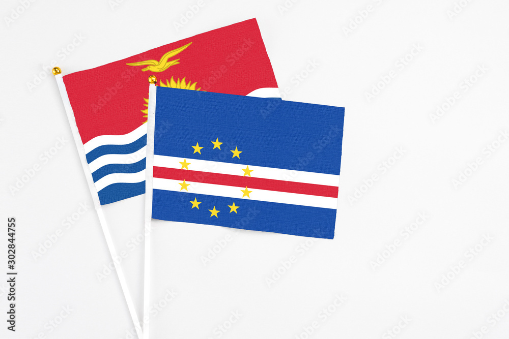 Cape Verde and Kiribati stick flags on white background. High quality fabric, miniature national flag. Peaceful global concept.White floor for copy space.