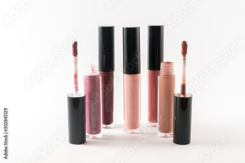 Fashion lip gloss collection of different colors and shades isolated on white background.