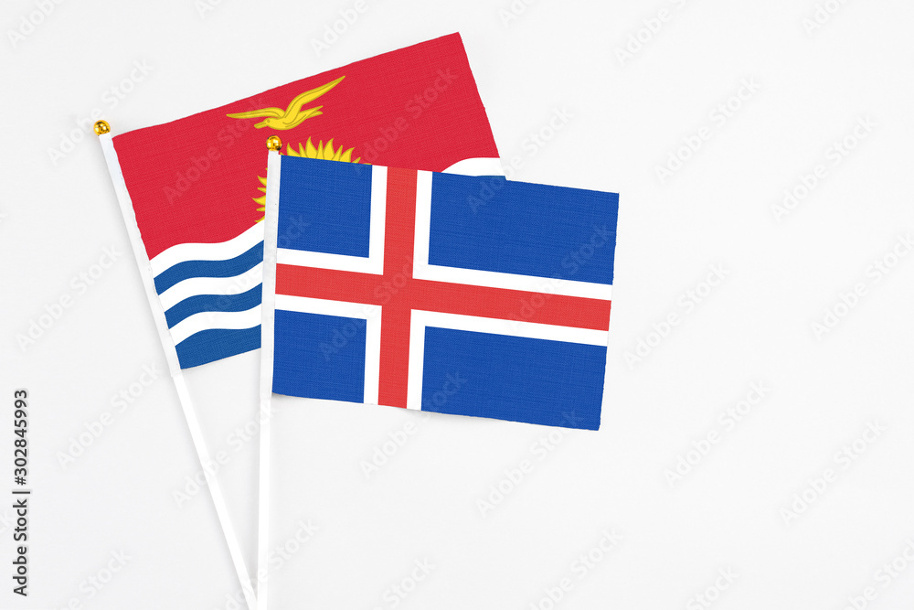 Iceland and Kiribati stick flags on white background. High quality fabric, miniature national flag. Peaceful global concept.White floor for copy space. Iceland and Kiribati stick flags on white background. High quality fabric, miniature national flag. Peaceful global concept.White floor for copy space.