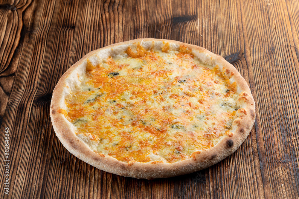 Hot four cheese pizza with melted mozzarella, cheddar, parmesan and blue cheese Hot four cheese pizza with melted mozzarella, cheddar, parmesan and blue cheese