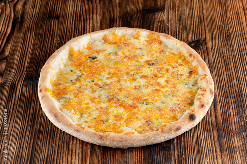 Hot four cheese pizza with melted mozzarella, cheddar, parmesan and blue cheese