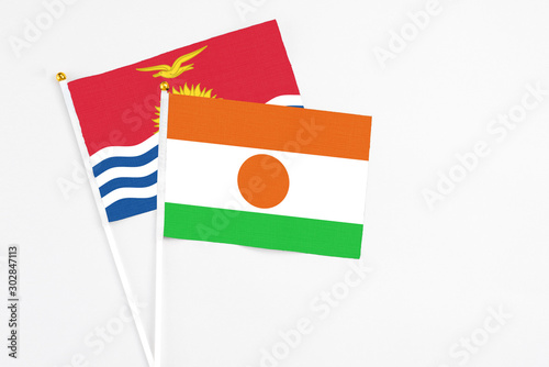 Free Download Niger and Kiribati stick flags on white background. High quality fabric, miniature national flag. Peaceful global concept.White floor for copy space. - GFXLoad