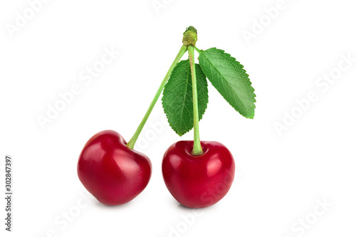 Two cherries with leaf closeup isolated on white background