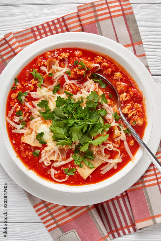 close-up of chicken lasagna soup in a bowl close-up of chicken lasagna soup in a bowl