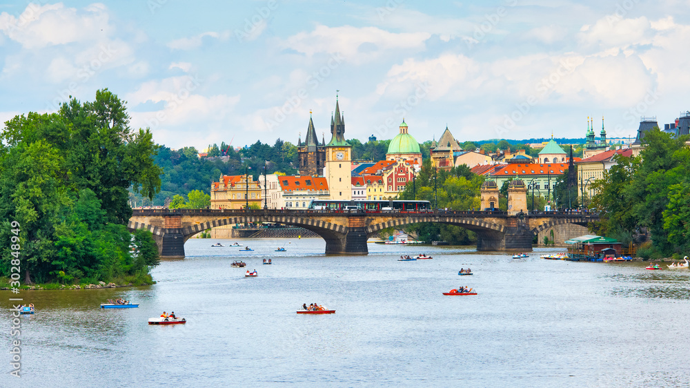 Tourists with pedaloes on the Vltava river in Prague - obrazy, fototapety, plakaty 