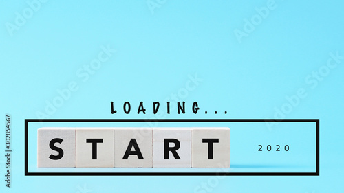 loading New Year 2020, start text on wood cube, mindset goal concept