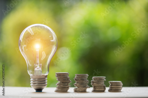coins and light bulb. concept saving money.