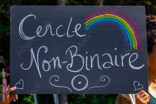 two hands holding French Homemade black poster, A closeup view of a French poster, saying Cercle Non-binary during a rally in Montreal, Canada photo
