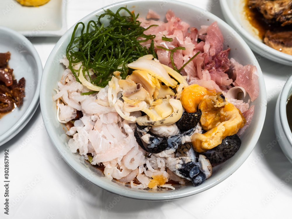 various seafood and chopped raw fishes in bowl