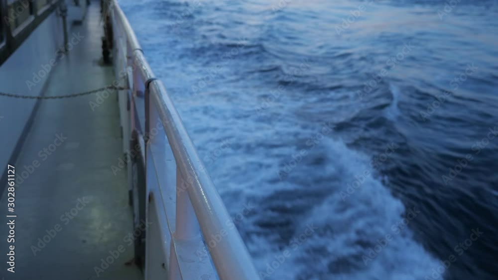 foamy deep blue waves disappear in boundless sea in late evening view from sailing tourist motorboat deck closeup foamy deep blue waves disappear in boundless sea in late evening view from sailing tourist motorboat deck closeup