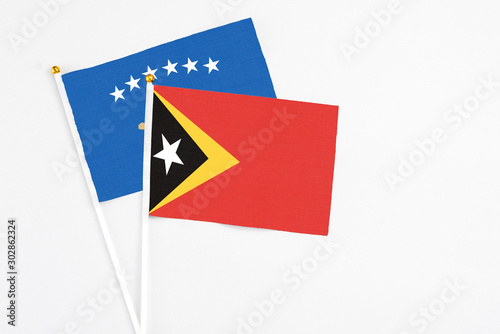 Free Download East Timor and Kosovo stick flags on white background. High quality fabric, miniature national flag. Peaceful global concept.White floor for copy space. - GFXLoad