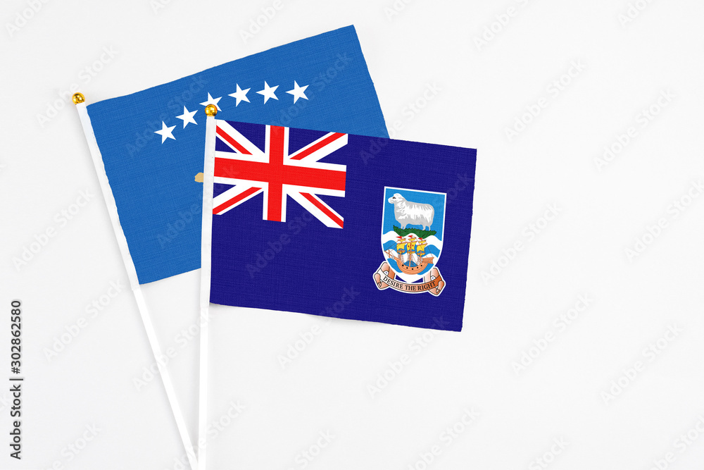 Fototapeta premium Falkland Islands and Kosovo stick flags on white background. High quality fabric, miniature national flag. Peaceful global concept.White floor for copy space.