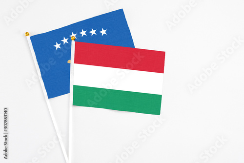 Hungary and Kosovo stick flags on white background. High quality fabric  miniature national flag. Peaceful global concept.White floor for copy space.