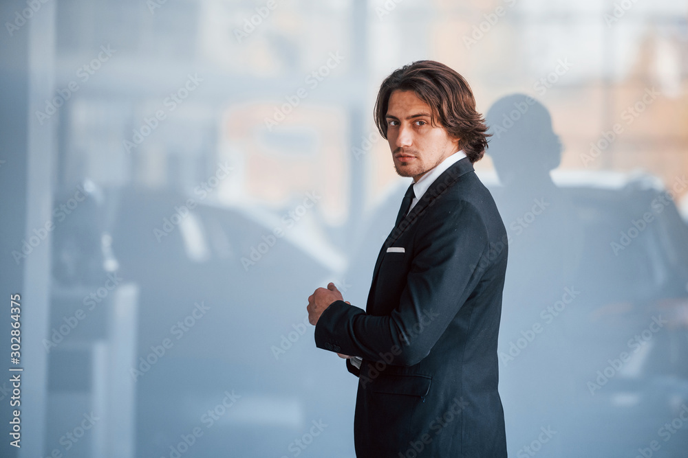 Portrait of handsome young businessman in black suit and tie Portrait of handsome young businessman in black suit and tie