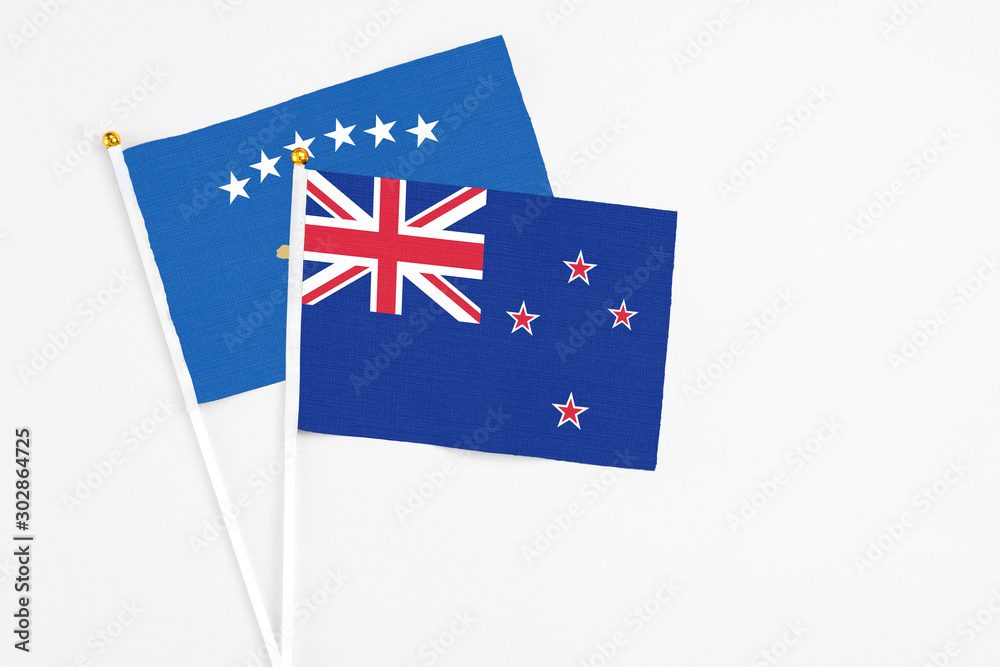 Fototapeta premium New Zealand and Kosovo stick flags on white background. High quality fabric, miniature national flag. Peaceful global concept.White floor for copy space.