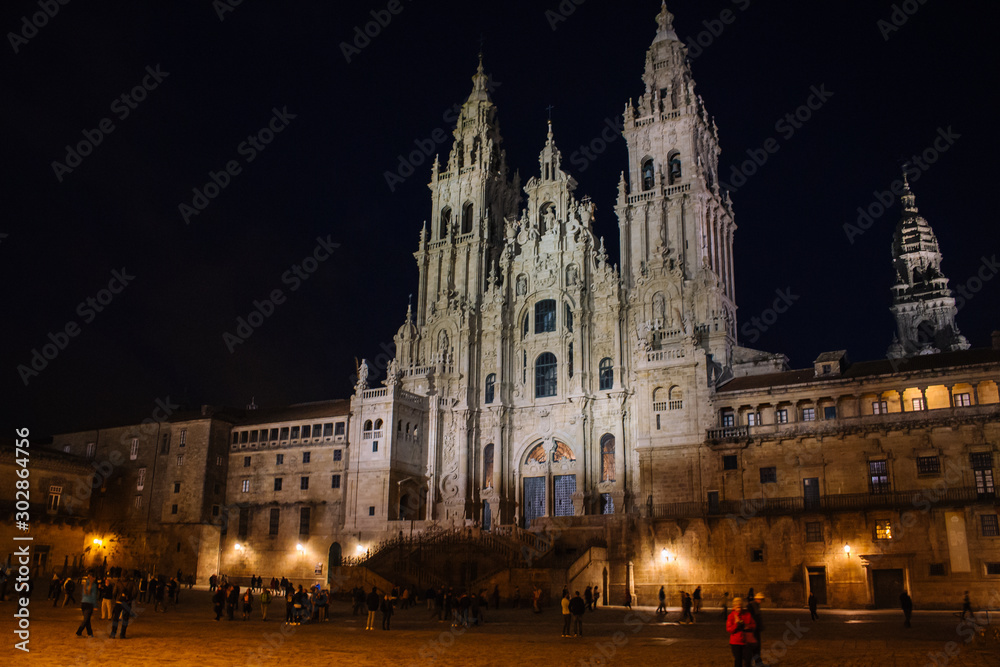 Santiago de Compostela, Spain - 10/18/2018: Square near illuminated Cathedral of Saint James in Santiago de Compostela. Famous cathedral on Camino de Santiago at night. Pilgrimage concept.