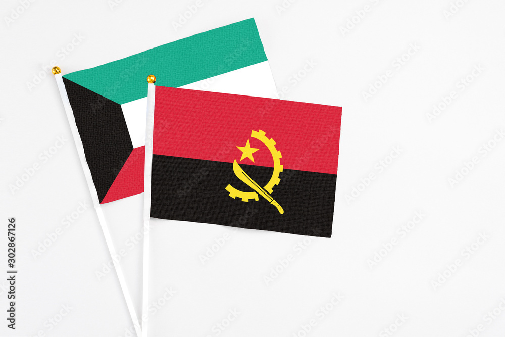 Angola and Kuwait stick flags on white background. High quality fabric, miniature national flag. Peaceful global concept.White floor for copy space. Angola and Kuwait stick flags on white background. High quality fabric, miniature national flag. Peaceful global concept.White floor for copy space.