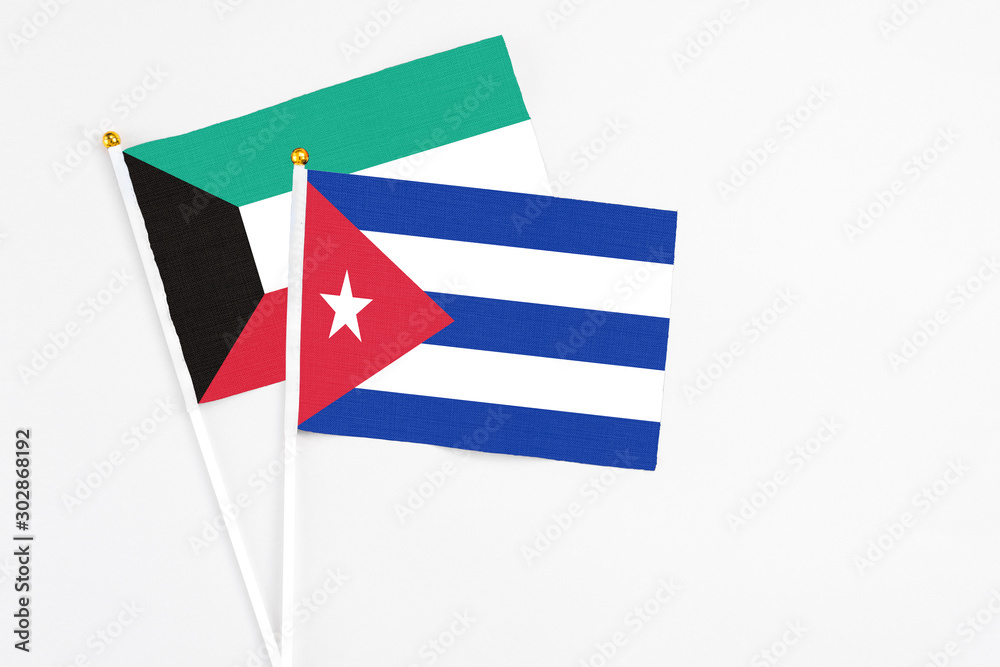 Cuba and Kuwait stick flags on white background. High quality fabric, miniature national flag. Peaceful global concept.White floor for copy space. Cuba and Kuwait stick flags on white background. High quality fabric, miniature national flag. Peaceful global concept.White floor for copy space.