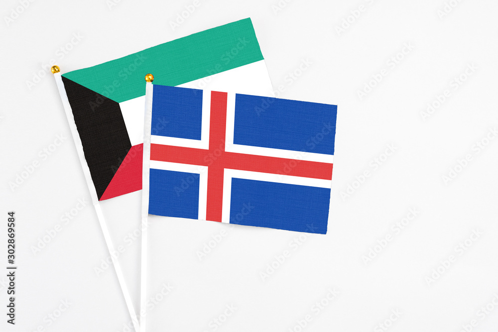 Iceland and Kuwait stick flags on white background. High quality fabric, miniature national flag. Peaceful global concept.White floor for copy space. Iceland and Kuwait stick flags on white background. High quality fabric, miniature national flag. Peaceful global concept.White floor for copy space.