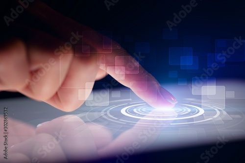 Finger touching tablet with identification concept and dark background