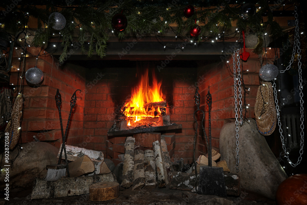 decorated christmas fireplace at night - obrazy, fototapety, plakaty 