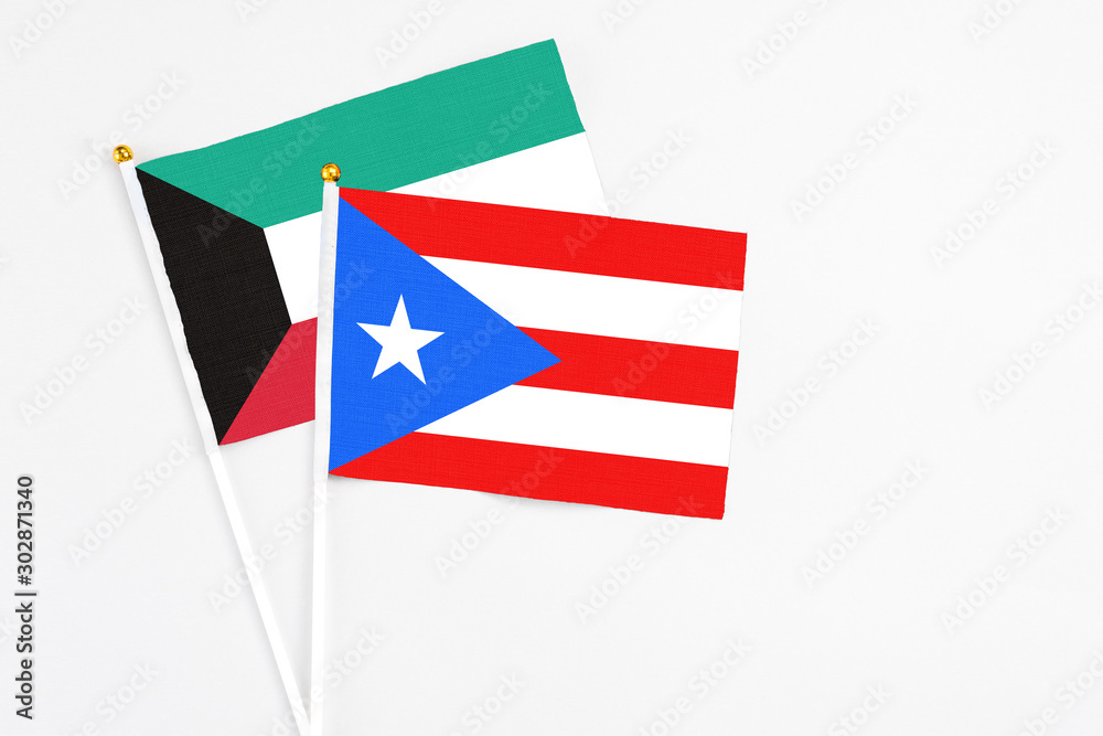 Puerto Rico and Kuwait stick flags on white background. High quality fabric, miniature national flag. Peaceful global concept.White floor for copy space.