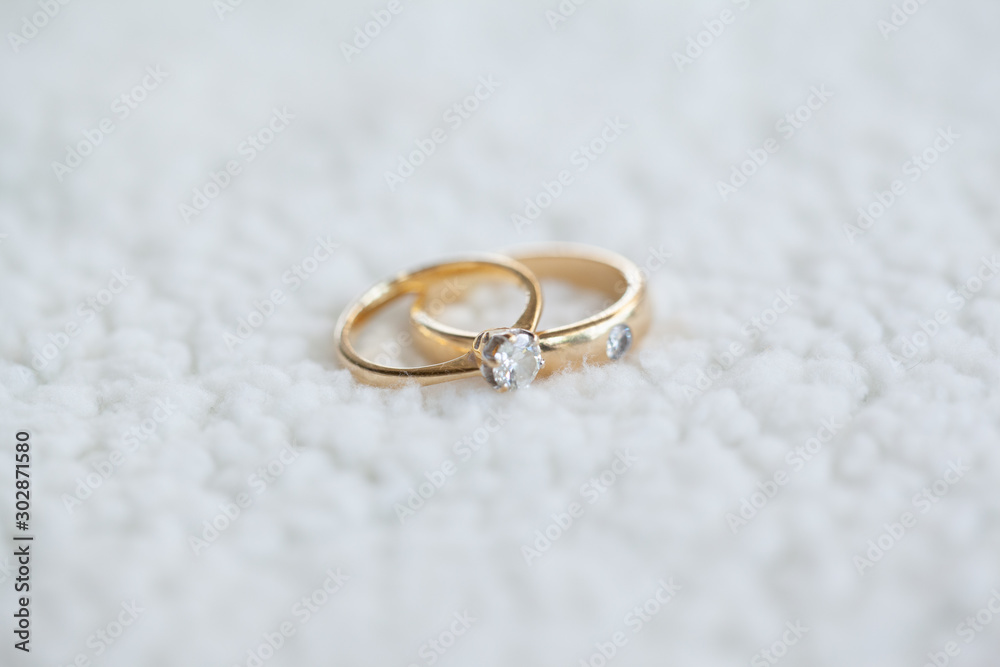 Diamond wedding rings on white soft wool Diamond wedding rings on white soft wool