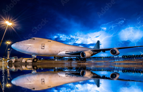 big aircraft in bad weather with rain drop in reflection